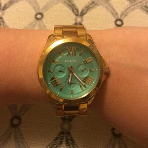 FOSSIL gold watch with teal face